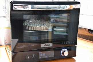 预热时间结束将派皮送入预热好的烤箱中层，按“启动”键，烤箱开始烘烤