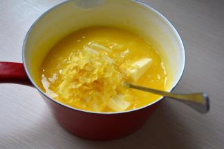 将鸡蛋液锅端离热水，将柠檬屑和黄油投入其中，迅速搅拌融化