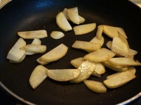 煎好的香肠盛出，锅中留底油，将土豆片煎至周边焦黄