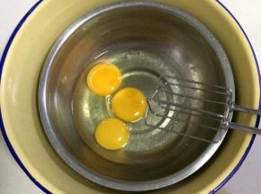 把鸡蛋打入打蛋盆内，坐在放有热水的盆内。