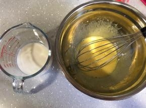 将混合好的牛奶和油加入蛋黄，分三次倒，每一次搅拌均匀了再加入下一次。