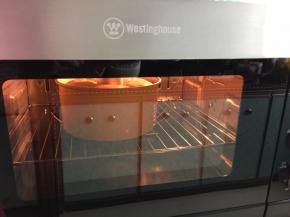 然后将拌好的蛋糕糊距离20厘米高处倒入容器中，震泡两下，放入预热的烤箱中层，上下火，170摄氏度40分钟，最后10分钟开热旋风