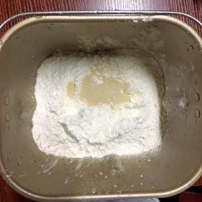 牛奶，面粉和酵母放入面包机桶里，揉面程序15分钟，到达光滑，盖上保鲜膜静止