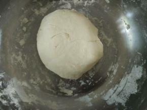 盘里倒入300克面粉，加入半匙盐，一边倒水一边用筷子拌成絮状，揉成光滑面团