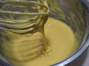 以不规则的方向搅拌均匀，无干粉颗粒，提起打蛋器，蛋黄糊能比较顺畅呈丝带状垂落下来，放一旁静置备用