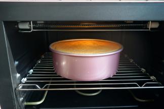 蛋糕回落，与模具持平，出炉，立即端起模具轻轻震几下，将蛋糕内部多余的热气震出，然后倒扣在晾架上