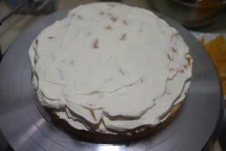 取一片蛋糕，先抹一层奶油，再铺上橙子丁，再抹一层奶油，扣上一层蛋糕片