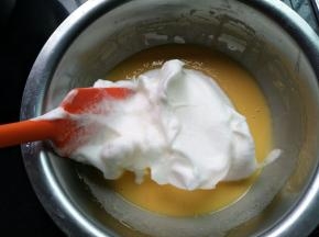 取一半蛋白霜与蛋黄湖混合，采用上下翻拌手法