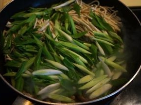 将豆腐丝和青蒜全部倒入锅中，不停翻炒