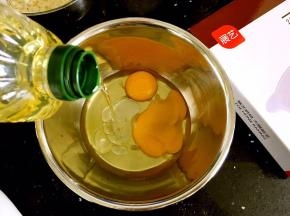 料理盆中打入鸡蛋、倒入芥花油。