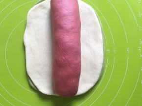 把红色面团卷起来，抹茶面团上方原色面团，最后放上卷好的红面团