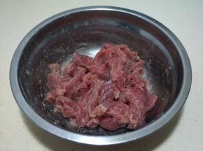 牛肉切薄片，加少许料酒、一点盐、一小勺淀粉抓匀，腌一会儿