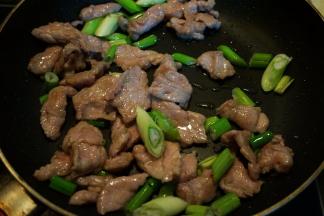 将葱段入锅中炒出香味，此时肉片也全部变色了