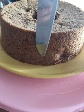 使用水果刀在戚风蛋糕中垂直戳洞。在戳洞前，用刀比一下大概的高度，如图示意洞的高度。