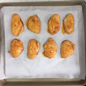 腌好的鸡翅放入烤盘内，烤箱预热200度，上下火，25分钟