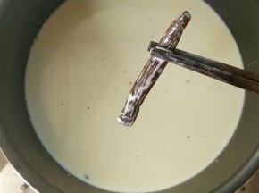 取出香草荚，倒入吉利丁液，搅拌至完全融合。