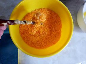 把拌好鸡蛋液和面粉的鸡肉块放在面包糠中裹满面包糠