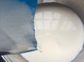 牛奶倒入容器中，加入细砂糖。