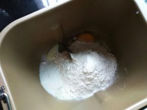 冰牛奶和鸡蛋液先倒入面包机，糖和盐对角分开放，再放高筋面粉和酵母