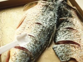 鱼身上抹盐，烤盘刷一些油，把鱼放入腌制20分钟。