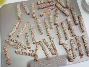 将融化的白巧克力放入裱花袋，在饼干上挤上线条，晾凉后凝固即可。