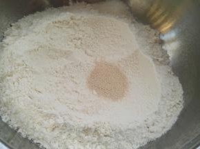 面粉倒盆里，白糖倒边上，挖个洞放入酵母。