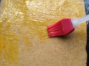 操作台上贴一张保鲜膜，把面团放上用擀面杖擀开成长方形状。