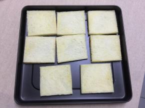 将吐司片铺在不粘烤盘中