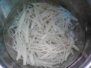 金针菇切去根部，用沸水焯烫至软，浸入冷水过凉