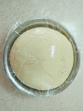 和出带有扩展性光滑的面团，放到盆里盖上保鲜膜，进行发酵2.5倍大。