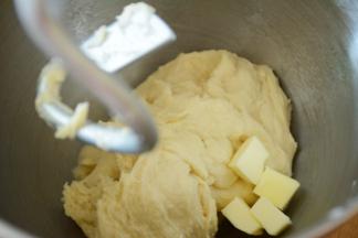 将除黄油，黑芝麻以外的材料先液体后干粉的顺序放入厨师机，注意尽量避免让盐和酵母接触。揉至10分钟后，面团光滑加入切小块的黄油，继续揉面。