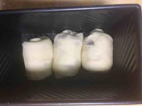 收口朝下放入吐司盒，放温暖处发酵至九分满
