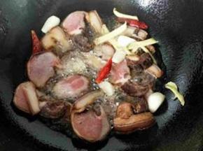 铁锅烧热放入适量植物油返给腊肉，葱姜蒜干辣皮慢慢翻炒。