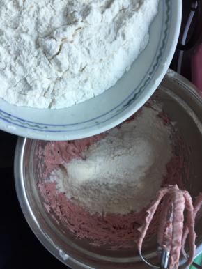 然后加入过筛的面粉，倒入一半搅拌