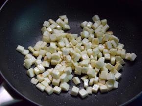 再起油锅，将茭白丁煸炒干水分开始变焦黄