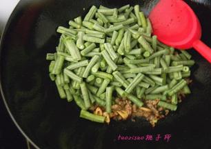 再倒入切好的豇豆煸炒；