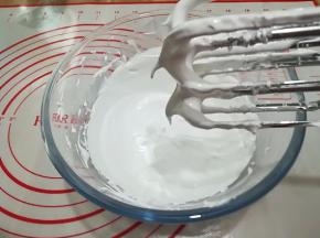 5. 将糖水慢慢倒入已打发好的蛋白中，边倒边用打蛋器搅打，打至蛋白霜降到40度左右