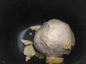 放入室温软化的黄油继续揉面至可抻出又薄又韧的手套膜完全阶段。