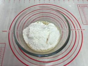 5.将过完筛的低筋面粉和泡打粉，加入蛋液中用手打动打蛋器拌匀。切勿画圈，防止起筯