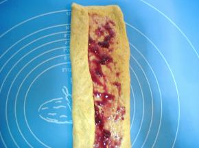 在面片上抹上适量蓝莓酱（蓝莓酱不要抹太多，要不卷起和烤制作过程中会漏馅。或者在蓝莓酱中加少许淀粉),面片头尾不要抹果酱，将面片两边向中间对折；