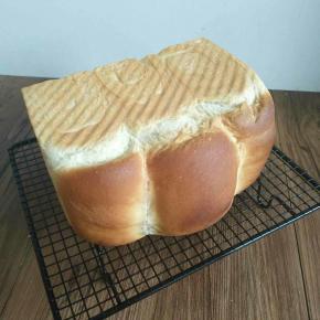 烤好马上取出，然后侧面放在凉架上，这样放是为了面包不会塌。