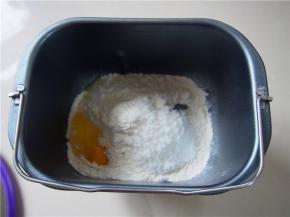 面粉称量好，加入盐和糖，在面包机桶的一侧放入鸡蛋