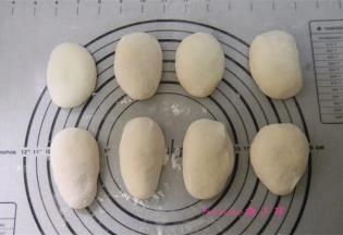 将面团取出放在揉面垫或者案板上，撒少许面粉揉光后，分成小剂子再揉光滑，松弛15分钟；