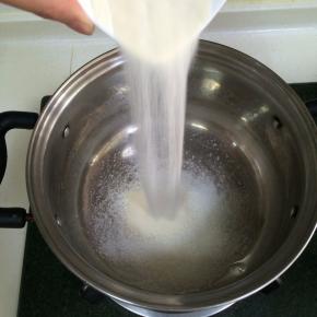 把细砂糖和吉利丁粉倒入不锈钢锅内。