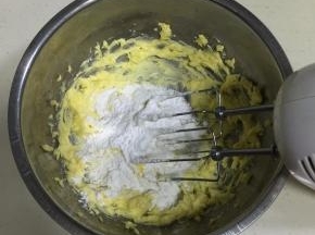 加入糖粉，用打蛋器搅拌均匀。（先用打蛋器稍微搅动下，以免搅打的时候飞溅起来。）