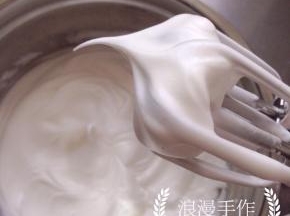 蛋白更加浓稠，提起打蛋器，蛋白出现弯弯的尖角时，停止打发。已经是湿性发泡的状态。