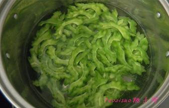 煮锅内水开后放入2克食盐，放入苦瓜片焯烫后，捞出过凉水浸泡15分钟；
