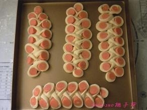 将做好的面包胚放入烤盘里，包好保鲜袋，进行二次醒发1小时；