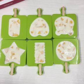 加入芒果丁至满模，用手轻轻按压，使芒果丁与酸奶混合。