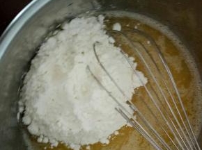 再往里面倒入称量好的低粉，用手动打蛋器画Z字拌均匀。